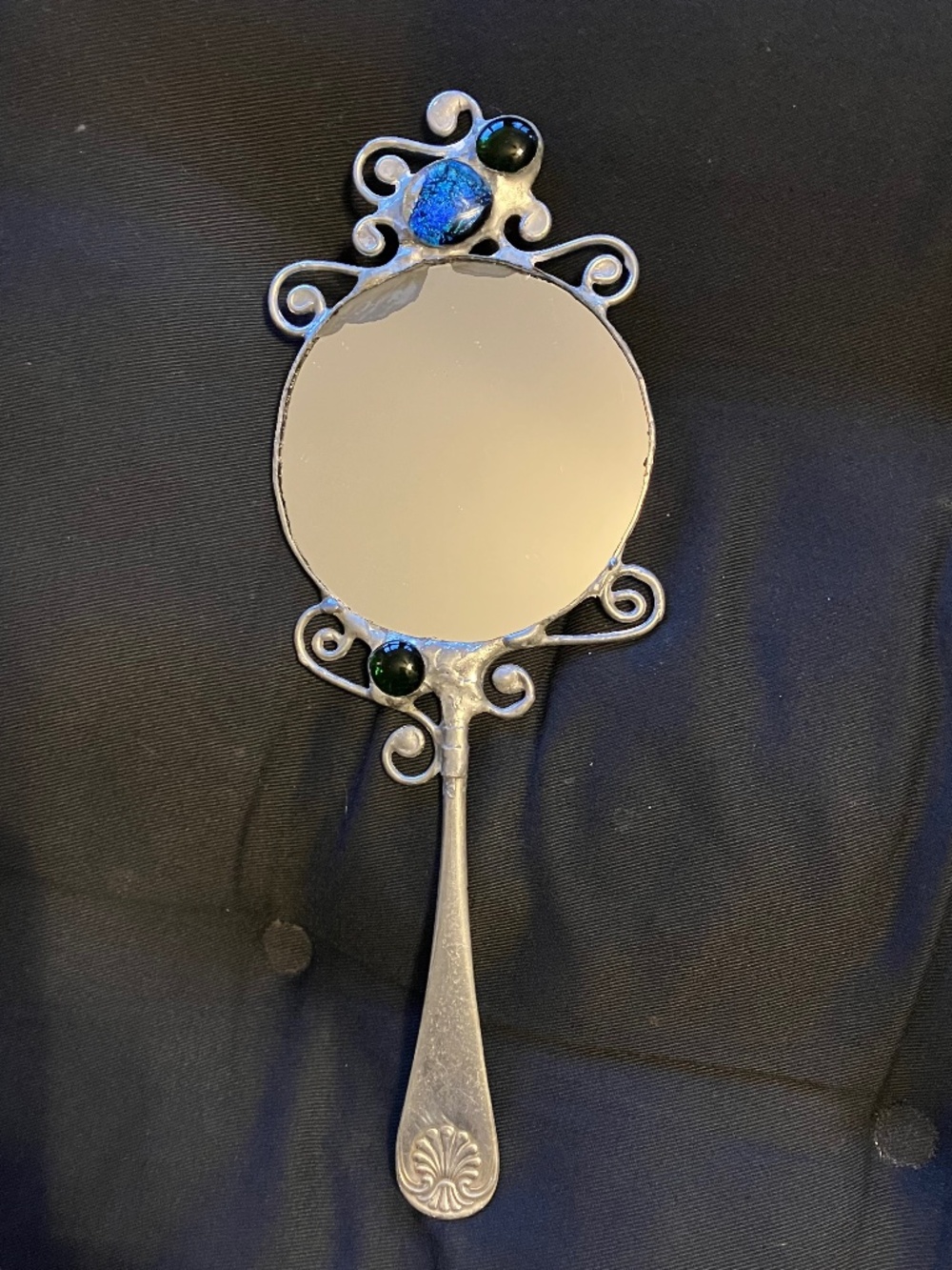 HAND HELD MIRROR, HAND MADE. HANDLE IS MADE FROM A PIECE OF VINTAGE SILVERWARE